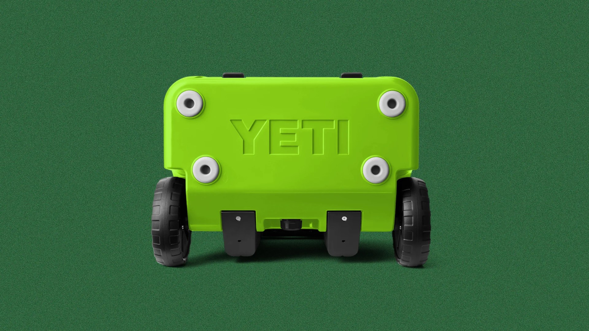 Bright green YETI cooler viewed from the bottom showing four white feet and two black wheels on a green background.